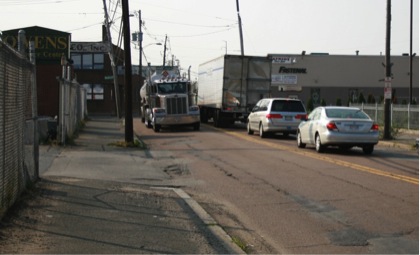 FIGURE 11. Second Street in Everett: Very Narrow and in Poor Condition
Figure 11 shows a gasoline tanker semi-trailer passing a refrigerated semi-trailer at a narrow point on Second Street.